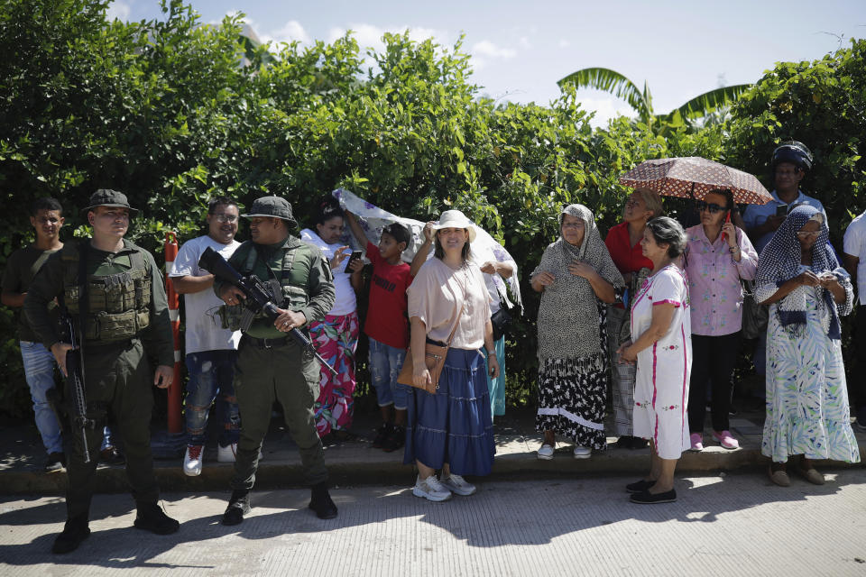 Neighbors of Luis Manuel Díaz wait for his arrival outside his home in Barrancas, Colombia, after he was released by his kidnappers, Thursday, Nov. 9, 2023. Díaz, the father of Liverpool striker Luis Díaz, was kidnapped on Oct. 28 by the guerrilla group National Liberation Army, or ELN. (AP Photo/Ivan Valencia)