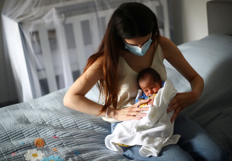 Emmanuelle Lteif Khnaisser, who was in labour at the moment of the Beirut port blast, holds her baby George at the family home in Jal el-Dib