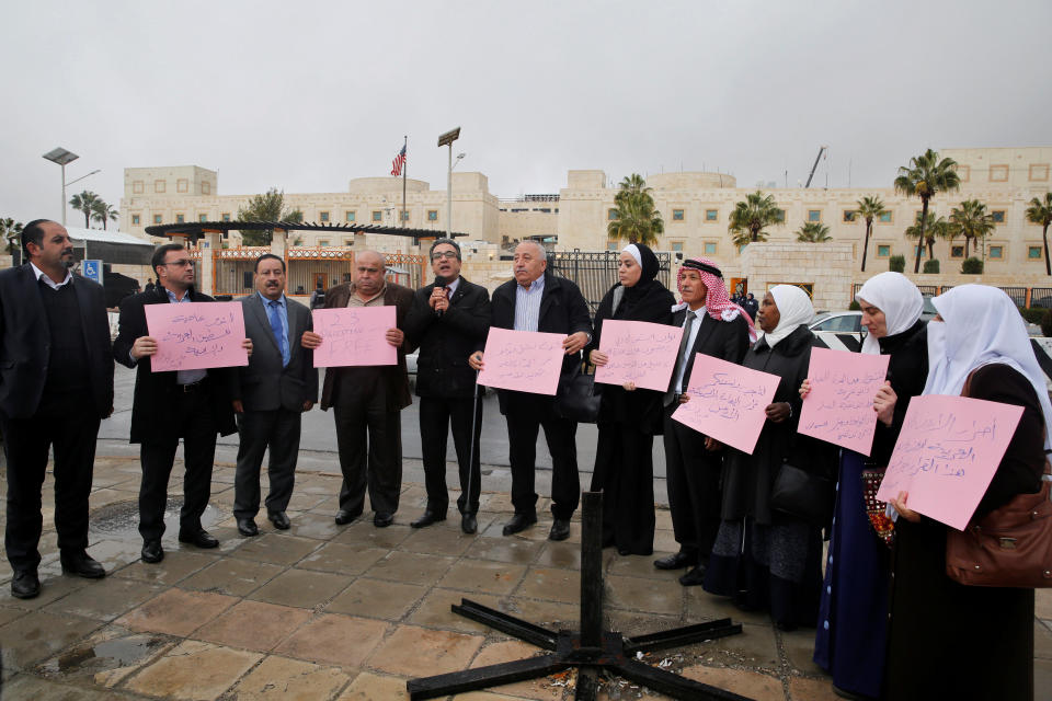 Jordanian members of Parliament hold signs during a sit-in against Trump's decision in front of the U.S. Embassy in Amman, Jordan, December 6, 2017.&nbsp;