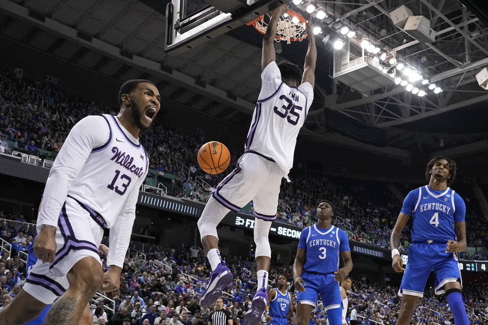 Kansas State guard Desi Sills celebrates a dunk by forward Nae'Qwan Tomlin against Kentucky during the first half of a second-round college basketball game in the NCAA Tournament on Sunday, March 19, 2023, in Greensboro, N.C. (AP Photo/Chris Carlson)