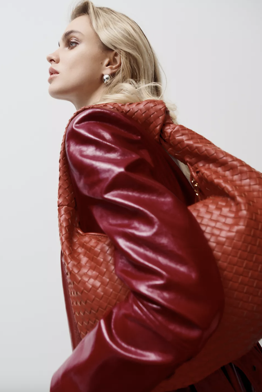 Blonde model in red leather jacket and red Mary Bianco Brigitte large bag (photo by Anthropologie)