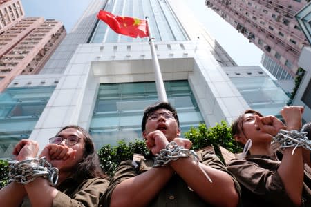 Students chain up themselves as they protest to demand authorities to scrap a proposed extradition bill with China, in Hong Kong