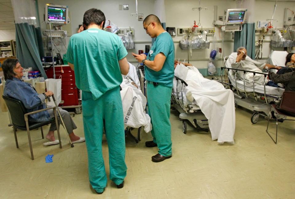 In this file photo of March 16, 2010, patients await treatment in the busy emergency room at St. Vincent's Hospital in New York.