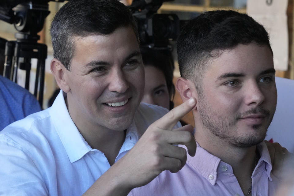 Santiago Pena, left, presidential candidate of the Colorado ruling party, and his son Gonzalo arrive at a polling station during general elections in Asuncion, Paraguay, Sunday, April 30, 2023. (AP Photo/Jorge Saenz)