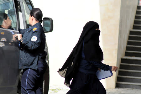 A woman repatriated to Kosovo from Syria enters the Basic Court in Pristina, Kosovo, April 23, 2019. REUTERS/Laura Hasani