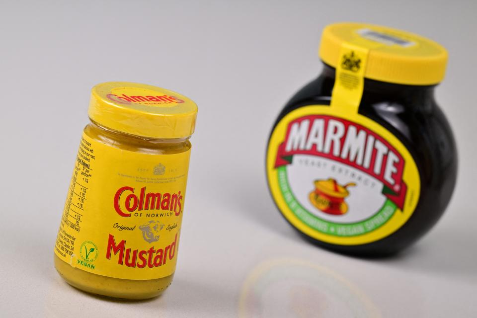 A photograph taken on March 19, 2024 shows a jar of Colman's mustard and a jar of Marmite, brands that are part of the British consumer goods giant Unilever. Unilever said on March 19, 2024 it would separate its ice cream unit, whose top-selling products include Ben & Jerry's and Magnum, in a likely demerger set to contribute to thousands of job cuts. Creating a standalone ice cream company is part of a major overhaul that would 