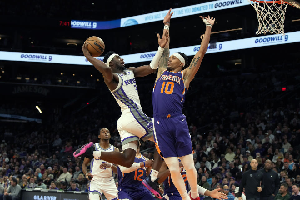 Sacramento Kings guard Terence Davis drives on Phoenix Suns guard Damion Lee (10) during the first half of an NBA basketball game, Tuesday, Feb. 14, 2023, in Phoenix. (AP Photo/Rick Scuteri)