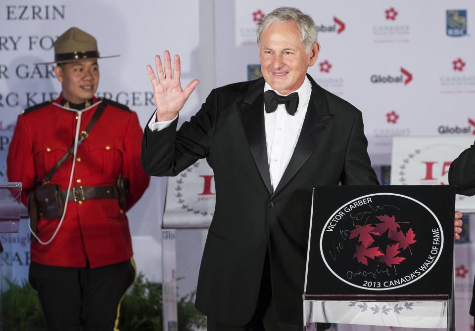 Actor Victor Garber stands by his star during Canada's Walk of Fame induction ceremonies in Toronto, September 21, 2013. REUTERS/Mark Blinch (CANADA - Tags: ENTERTAINMENT)