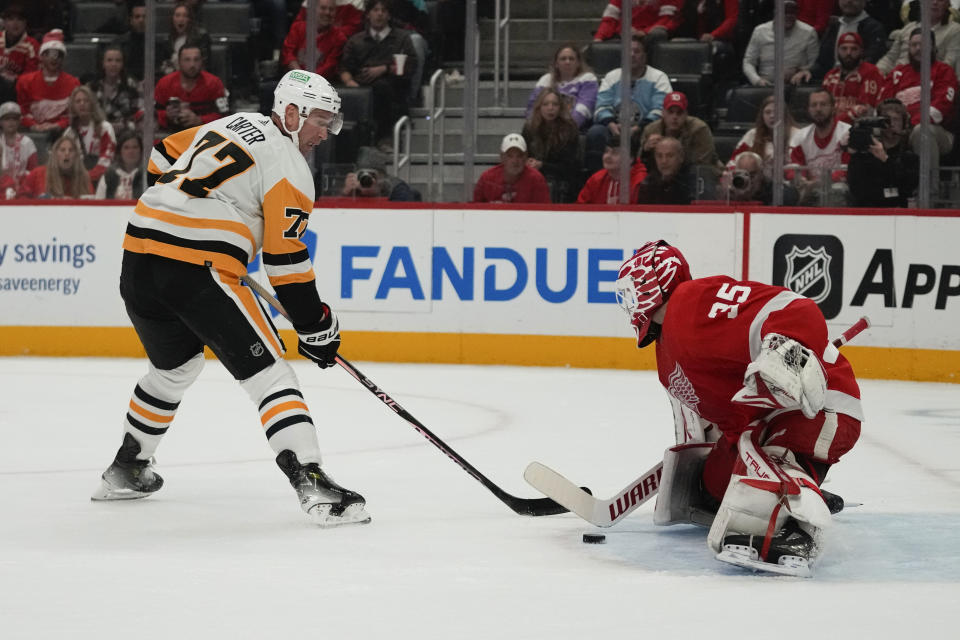 Detroit Red Wings goaltender Ville Husso (35) stops a Pittsburgh Penguins center Jeff Carter (77) shot in the first period of an NHL hockey game Wednesday, Oct. 18, 2023, in Detroit. (AP Photo/Paul Sancya)