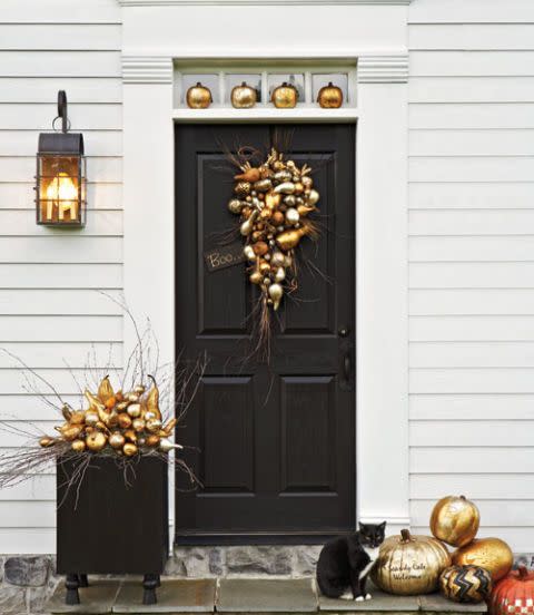 <p>Mixed metals can make even gourds look glam. Think beyond orange, yellow, and red—silver and gray tones are cool, fresh, and modern. We're all about these metallic-painted pumpkins on this front porch. </p><p>Get the tutorial at <a href="http://www.countryliving.com/diy-crafts/how-to/g616/how-to-guild-a-pumpkin/" rel="nofollow noopener" target="_blank" data-ylk="slk:Country Living" class="link "><em>Country Living</em></a>. </p>