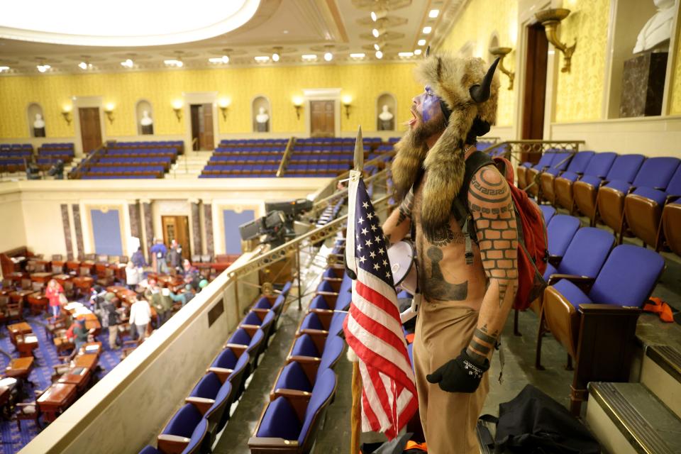 Jake Angeli of Arizona yells inside the Senate Chamber on January 06, 2021 in Washington, DC. Congress held a joint session today to ratify President-elect Joe Biden's 306-232 Electoral College win over President Donald Trump. Pro-Trump protesters entered the U.S. Capitol building during mass demonstrations in the nation's capital.