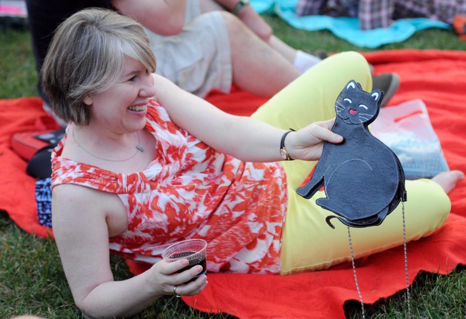 Jeanne Morales of Minneapolis shows her cat purse before the start of the Walker Art Center's first "Internet Cat Video Film Festival," showcasing the best of cat films on the Internet in Minneapolis Thursday, Aug. 30, 2012. The Walker Art Center in Minneapolis held its first-ever online cat video festival, a compilation of silly cat clips that have become an Internet phenomenon, attracting millions of viewers for some of the videos. (AP Photo/Craig Lassig)