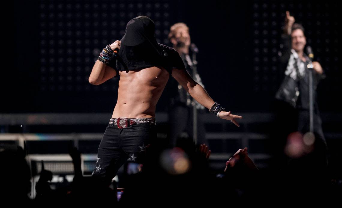 Donnie Walhberg pulls his shirt over his head as he shows off his famous torso with New Kids on the Block in concert on the “Mixtape 2022 Tour” at Raleigh, N.C.’s PNC Arena, Friday night, July 22, 2022.