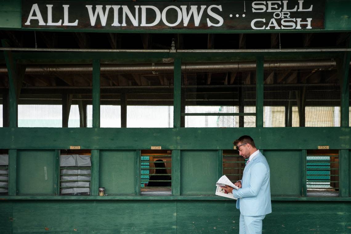 A spectator plans his wager on the day of the 148th Kentucky Derby at Churchill Downs in Louisville, Ky., Saturday, May 6, 2022. Bryan Woolston/email@bryanwoolston.com