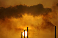 The sun sets behind Isla refinery in Willemstad at the island of Curacao June 16, 2008. REUTERS/Jorge Silva/File Photo