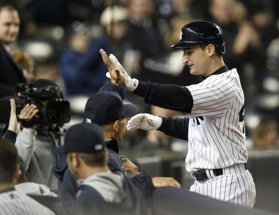 New York Yankees' Dean Anna greets teammates at the dugout steps after hitting a fifth-inning solo home run off Boston Red Sox starting pitcher Clay Buchholz in a baseball game at Yankee Stadium in New York, Thursday, April 10, 2014. (AP Photo/Kathy Willens)