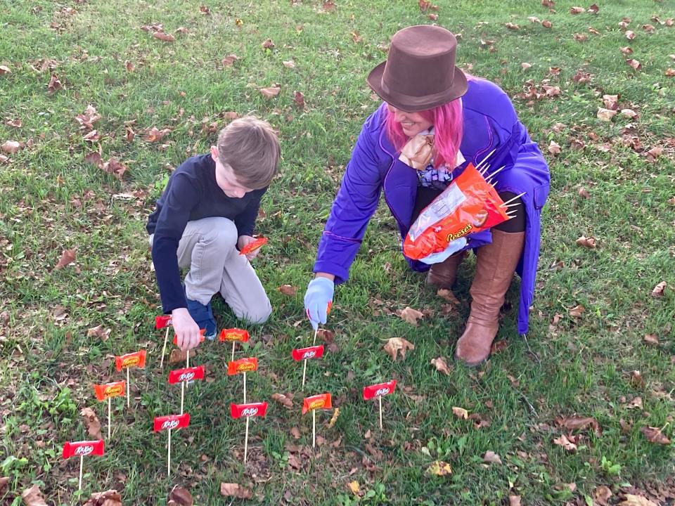 Lynn Rutecki and son, Jake, are planting a candy garden to match their Halloween costume theme of Willy Wonka and the Chocolate factory outside their Middletown, Penn., home.