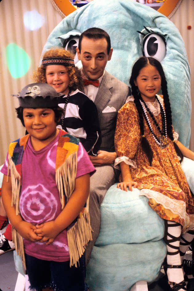 Natasha Lyonne sits on Paul Reubens lap during a promo still for “Pee-wee’s Playhouse” in 1986.
