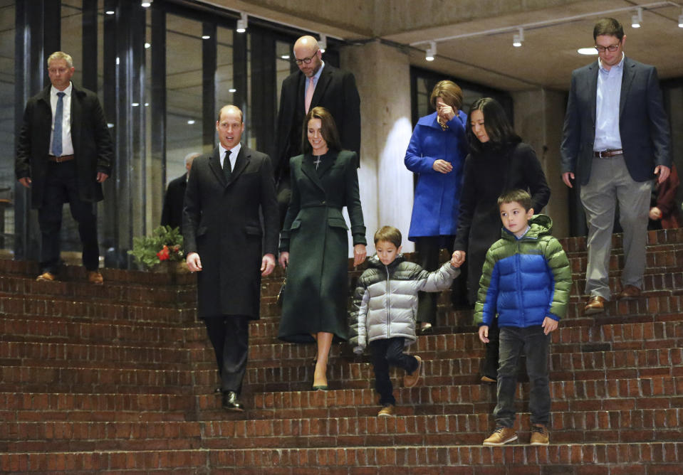 Boston Mayor Michelle Wu, back, second right, husband Conor Perwarski,top right, and sons Blaise, center, and Cass and Gov.-elect Maura Healey, back, third right, walk with Britain's Prince William and Kate, Princess of Wales, in Boston City Hall on Wednesday, Nov. 30, 2022, in Boston. The Prince and Princess of Wales are making their first overseas trip since the death of Queen Elizabeth II in September. (Nancy Lane/The Boston Herald via AP, Pool)