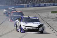 Jeb Burton, front, leaves a smoke trail after crashing during a NASCAR Xfinity Series auto race at Texas Motor Speedway in Fort Worth, Texas, Saturday, June 12, 2021. (AP Photo/Larry Papke)