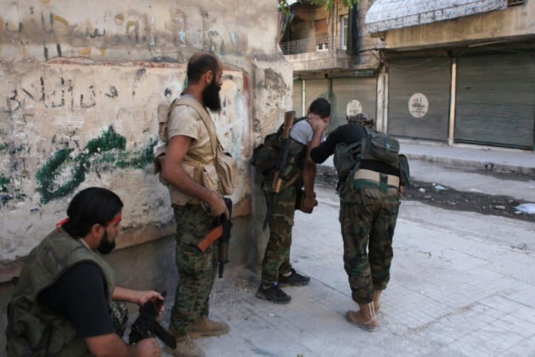 Syrian pro-government forces take part in an operation to take control of Aleppo's Suleiman al-Halabi neighbourhood, on September 30, 2016