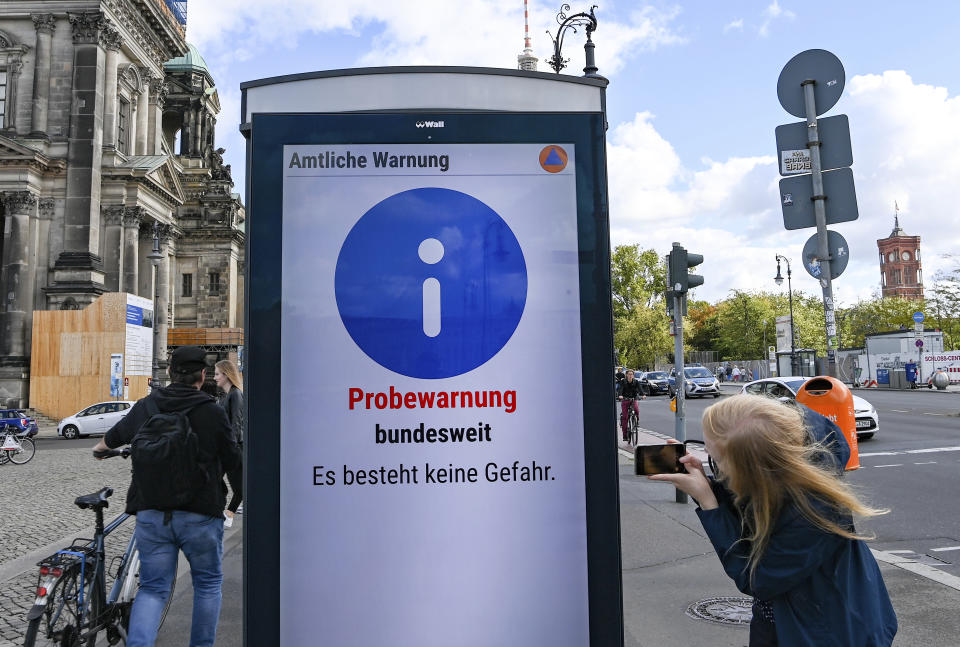 "Trial warning nationwide. There is no danger" is written at the first nationwide warning day on an information board in Berlin, Germany, Thursday, Sept. 10, 2020. For the first time in 30 years, Germany was planning a nationwide test of sirens on Thursday morning _ only the alarm didn't go off in some places and push alerts never arrived or popped up late on many users' smart phones. (Jens Kalaene/dpa via AP)