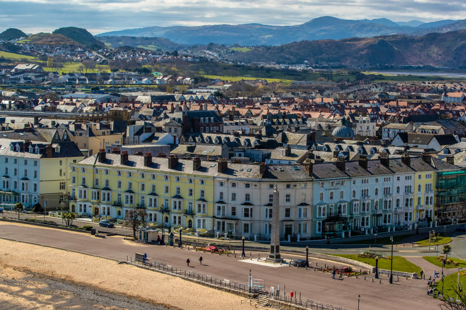 The seafront at Llandudno, north Wales, with dramatic landscape in the background (Getty Images)