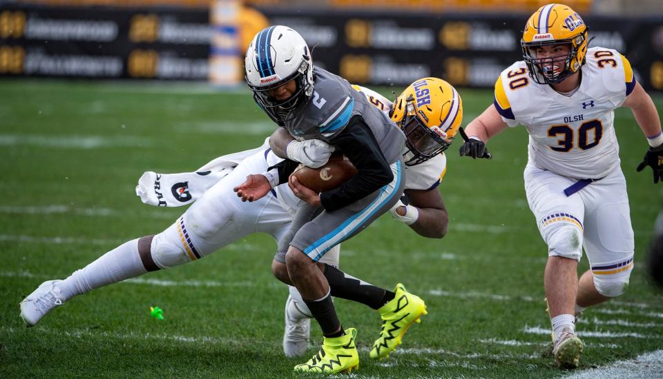 OLSH's Brandon Brazell watches teammate BJ Vaughn Jr tackle Bishop Canevin's Jason Cross during the WPIAl 1A championship Friday at Heinz Field.[Lucy Schaly/For BCT]