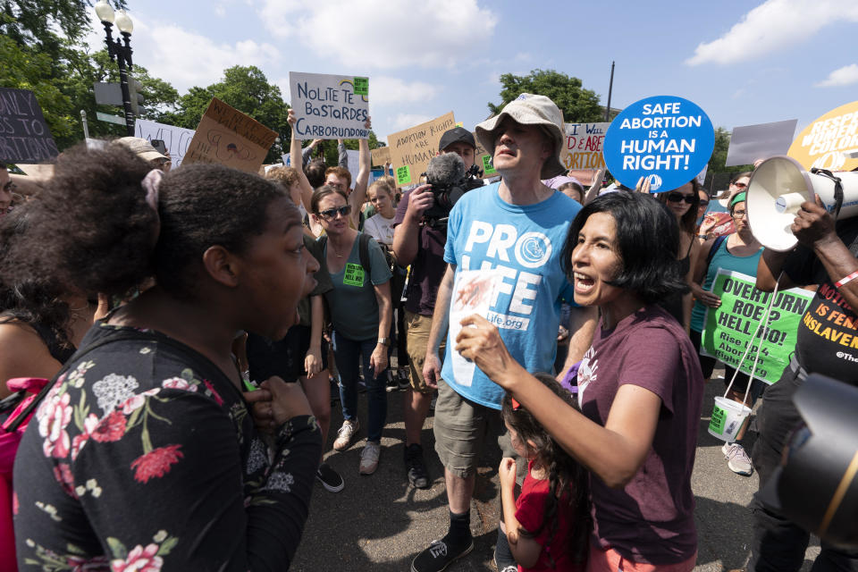 Anti-abortion demonstrators, right, argue with abortion-rights protesters outside the Supreme Court in Washington, on Friday, June 24, 2022.  / Credit: Jose Luis Magana / AP