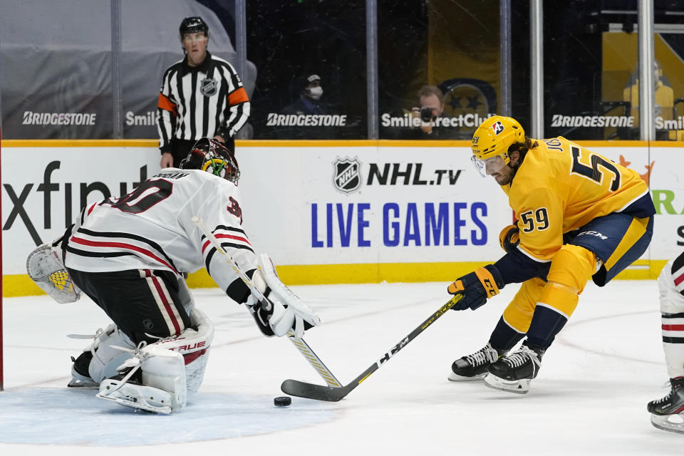 Nashville Predators defenseman Roman Josi (59) scores the winning goal against Chicago Blackhawks goaltender Malcolm Subban (30) in overtime of an NHL hockey game Tuesday, Jan. 26, 2021, in Nashville, Tenn. The Predators won 3-2. (AP Photo/Mark Humphrey)