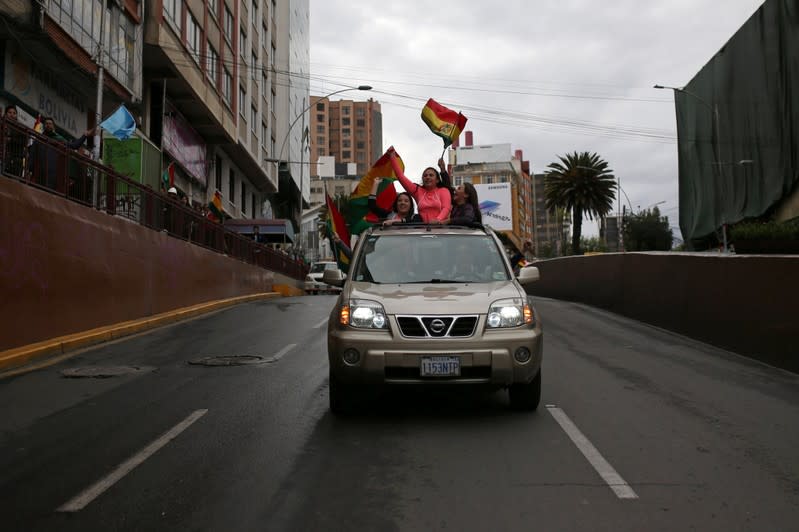 People celebrate after Bolivia's President Evo Morales announced his resignation in La Paz