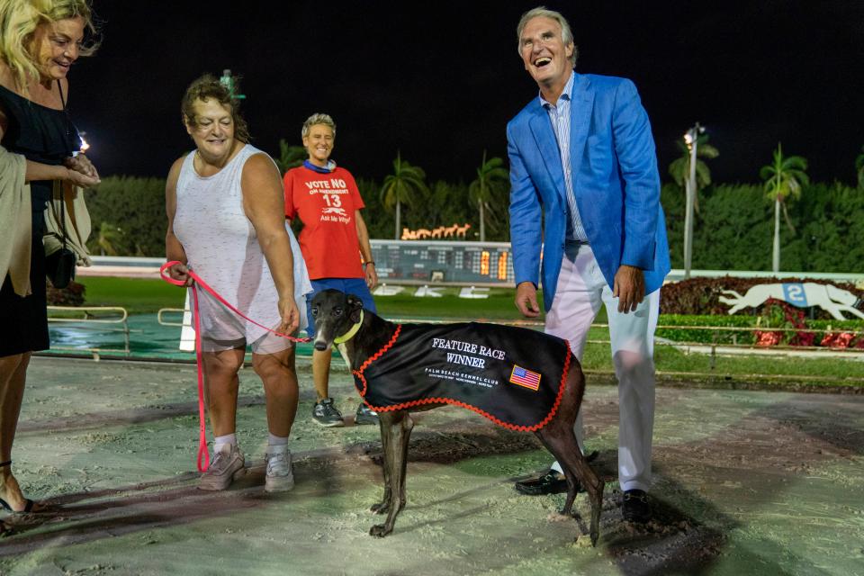 Sean Rooney, right, celebrates his birthday by congratulating feature race winner, Fortune and Fun, at the Palm Beach Kennel Club on the last day of legal dog racing on Dec. 31, 2020. The club had been racing greyhounds for 88 years.