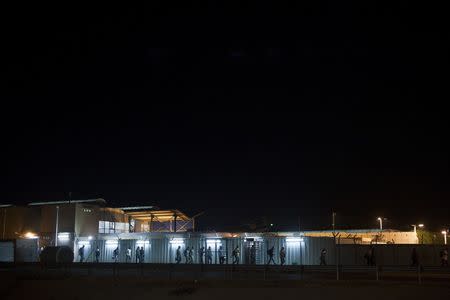 Palestinian labourers are seen as they cross through Israel's Eyal checkpoint from the West Bank town of Qalqilya, in this September 11, 2011 file photo. REUTERS/Nir Elias/Files