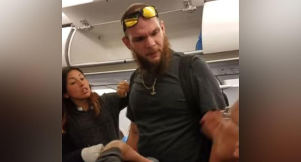 Matthew Silvay confronted another passenger who he claimed hit his pregnant wife Hazel Ramirez (left) and her service dog. Source: Joshua Manley / You Tube