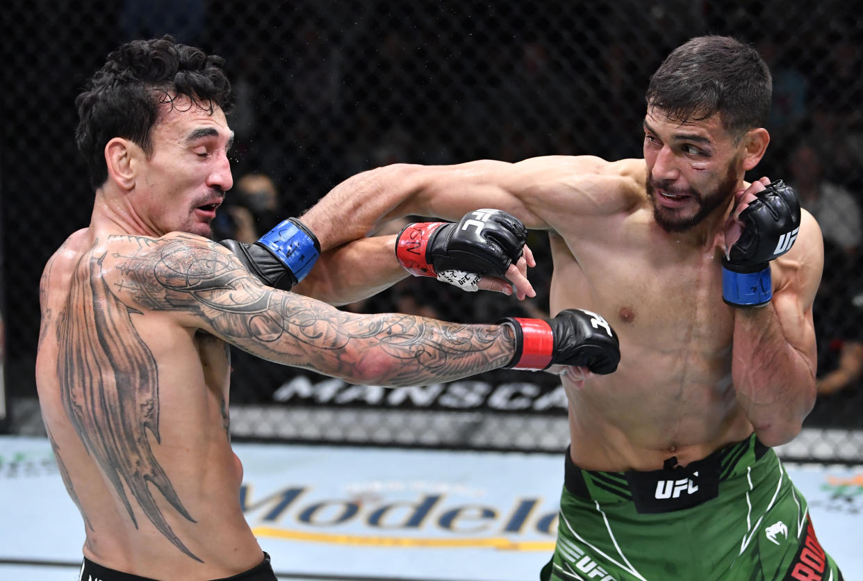 LAS VEGAS, NEVADA - NOVEMBER 13: (R-L) Yair Rodriguez of Mexico punches Max Holloway in a featherweight fight during the UFC Fight Night event at UFC APEX on November 13, 2021 in Las Vegas, Nevada. (Photo by Chris Unger/Zuffa LLC)