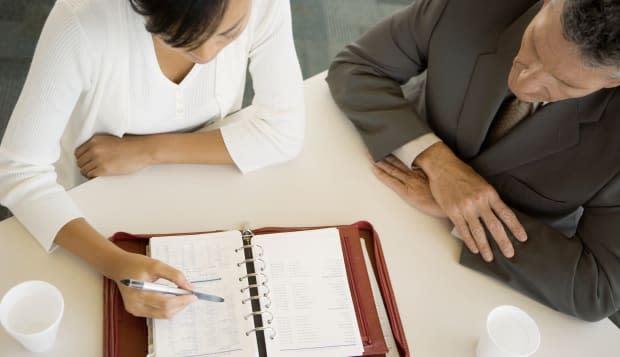 Executive and assistant looking at agenda together