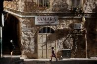 People walk in the Christian Quarter of Jerusalem's Old City June 21, 2016. REUTERS/Ronen Zvulun