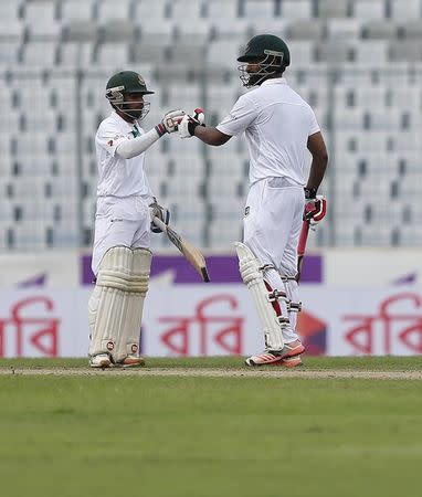 Cricket - Bangladesh v England - Second Test cricket match - Sher-e-Bangla Stadium, Dhaka, Bangladesh - 28/10/16. Bangladesh's Tamim Iqbal (R) celebrates with his teammate Mominul Haque after scoring his century. REUTERS/Mohammad Ponir Hossain