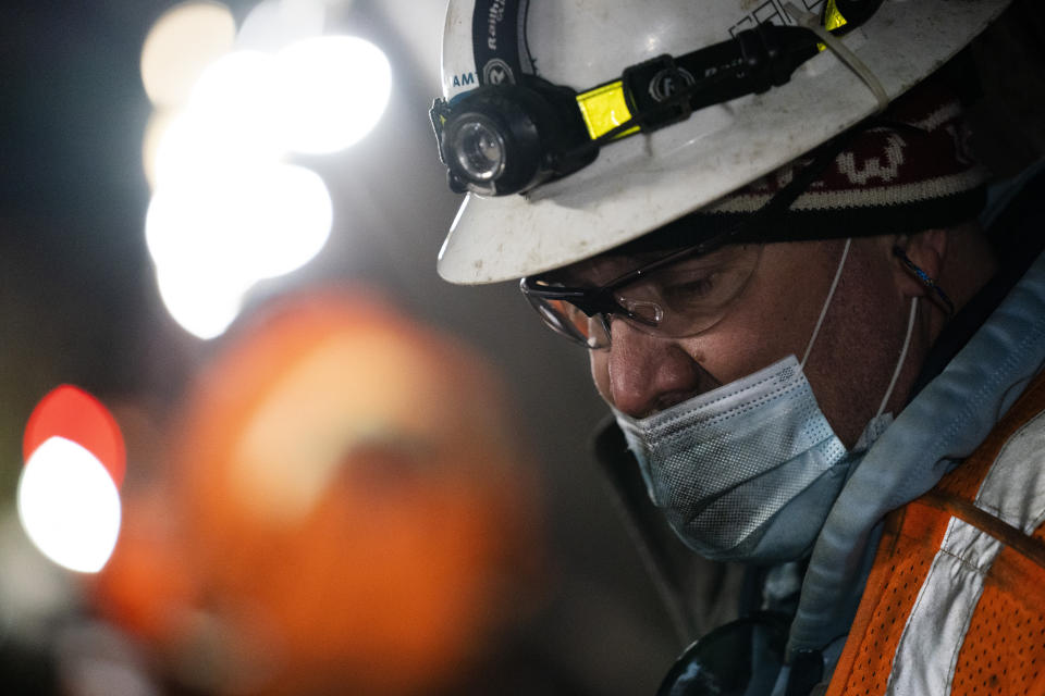 Amtrak workers perform tunnel repairs to a partially flooded train track bed, Saturday, March 20, 2021, in Weehawken, N.J. With a new rail tunnel into New York years away at best, Amtrak is embarking on an aggressive and expensive program to fix a 110-year-old tunnel in the interim. (AP Photo/John Minchillo)