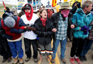 <p>Dakota Access Pipeline protesters square off against police between the Standing Rock Reservation and the pipeline route outside the little town of Saint Anthony, N.D., on Oct.5, 2016. (Photo: Terray Sylvester/Reuters) </p>