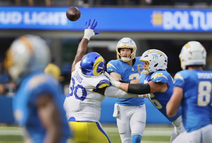 Inglewood, CA - August 17: Chargers quarterback Easton Stick passes the ball as he is pressured.