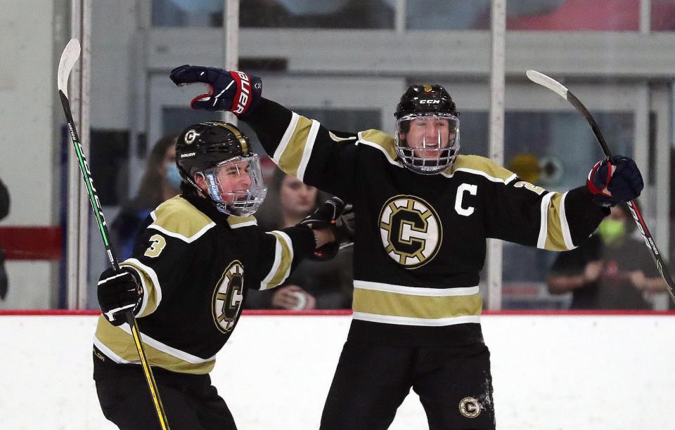 From right, Clarkstown's Nick Romeo (21) celebrates a first period goal against BYSNS with teammate Sam Sobler (3)  during hockey action at the Brewster Ice Arena Jan. 15, 2022. 