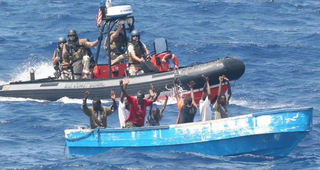 <span class="caption">Suspected pirates surrender to the U.S. Coast Guard off the coast of Somalia in 2009.</span> <span class="attribution"><a class="link " href="https://coastguard.dodlive.mil/2010/03/history-the-piracy-mission-then-and-now/" rel="nofollow noopener" target="_blank" data-ylk="slk:LCDR Tyson Weinert/U.S. Coast Guard;elm:context_link;itc:0;sec:content-canvas">LCDR Tyson Weinert/U.S. Coast Guard</a></span>