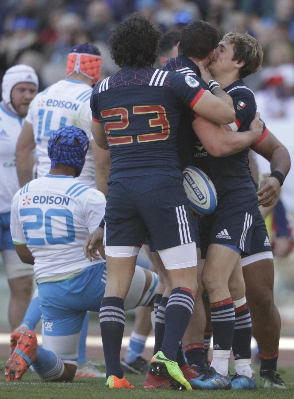 France's Louis Picamoles is celebrated by two teammates after scoring a try during a Six Nations rugby union international match between Italy and France at the Rome Olympic stadium, Saturday, March 11, 2017. (AP Photo/Gregorio Borgia))