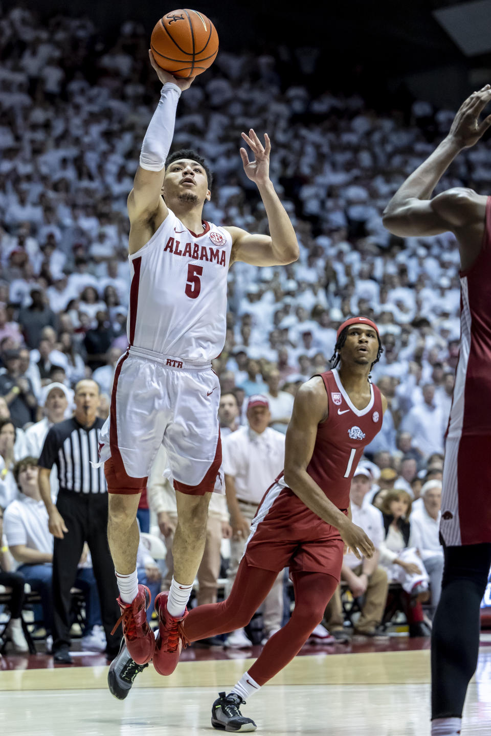 Alabama guard Jahvon Quinerly (5) works by Arkansas guard Ricky Council IV (1) for a shot during the second half of an NCAA college basketball game, Saturday, Feb. 25, 2023, in Tuscaloosa, Ala. (AP Photo/Vasha Hunt)