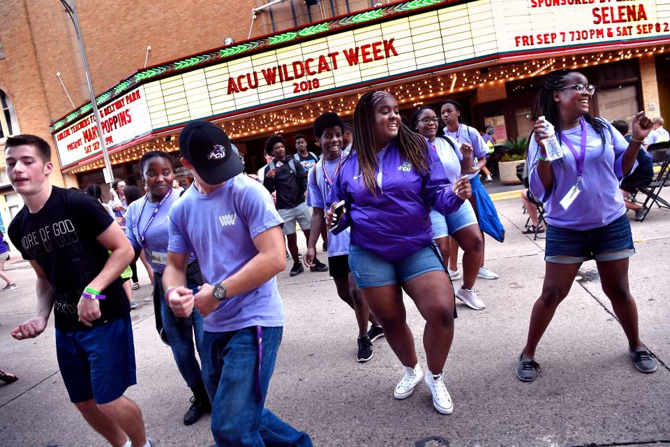 Incoming Abilene Christian University students dance to the Cuban Shuffle before entering the Paramount Theatre in August 2018.