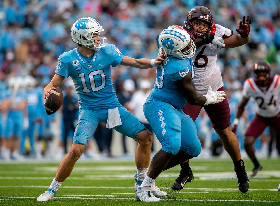 North Carolina lineman Ed Montilus (63) protects quarterback Drake Maye from Virginia Tech’s Josh Fuga (6) in the third quarter on Saturday, October 1, 2022 at Kenan Stadium in Chapel Hill, N.C. Maye threw for 363 yards and three touchdown in their 41-10 victory.