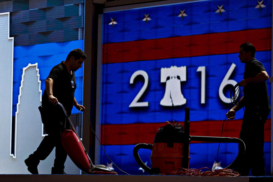 A worker vacuums carpeting before the start of the Democratic National Convention.