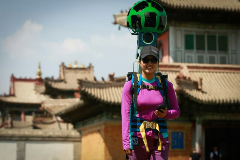 A Google Street View employee uses a specialized camera to record the surroundings of the Choijin Lama Museum in the Mongolian capital of Ulan Bator, on July 23, 2015