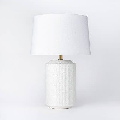 <p><strong>Threshold x Studio McGee</strong></p><p>target.com</p><p><strong>$69.00</strong></p><p><a href="https://www.target.com/p/ceramic-assembled-table-lamp-white-threshold-designed-with-studio-mcgee/-/A-79802545" rel="nofollow noopener" target="_blank" data-ylk="slk:BUY NOW;elm:context_link;itc:0;sec:content-canvas" class="link ">BUY NOW</a></p><p>The body of this table lamp features a textured ceramic. Great for nightstands, end tables, and accent tables, this lamp has dimmable setting that you can change to fit your mood. </p>